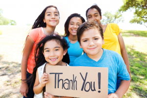 kids holding thank you sign